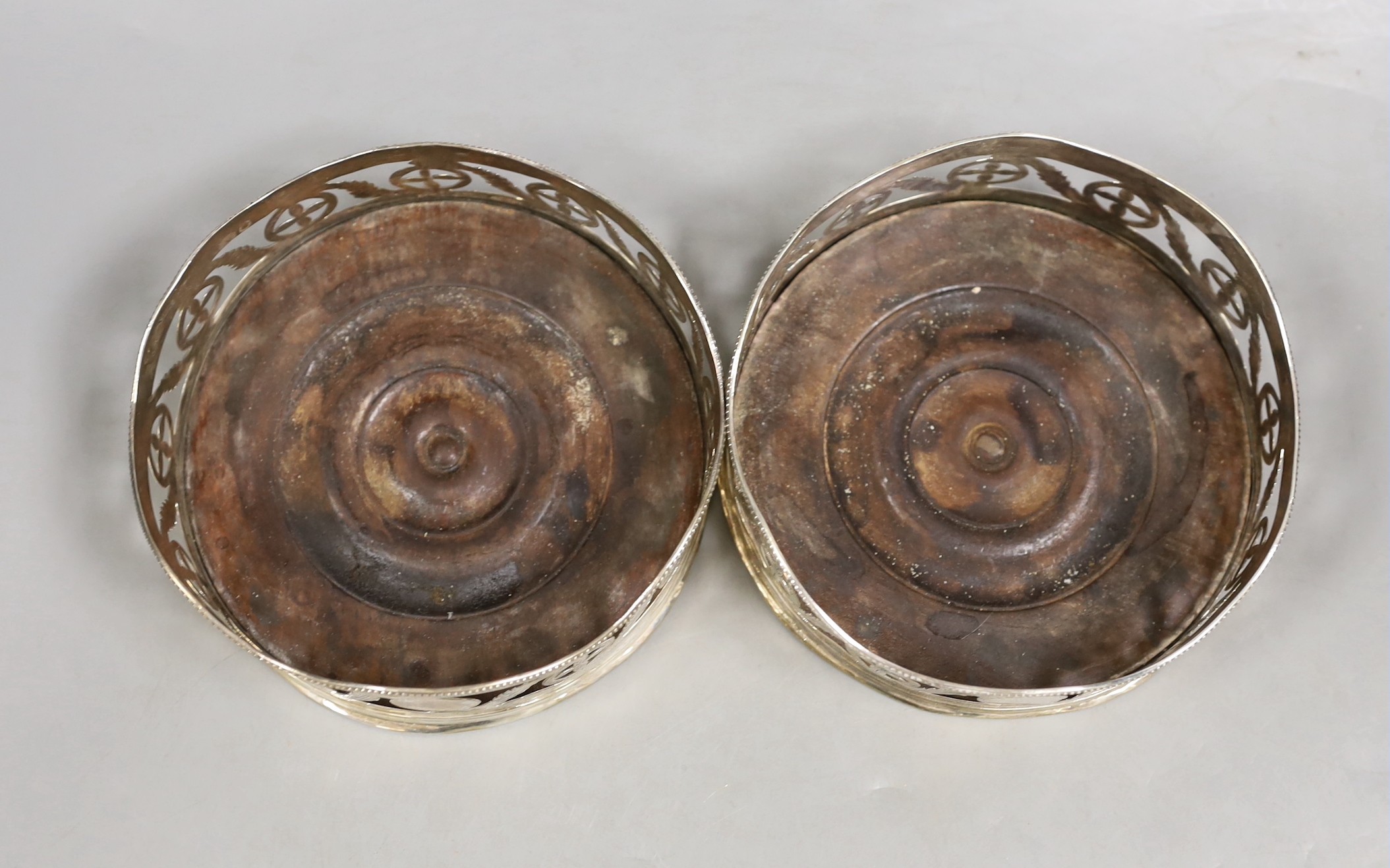 A pair of George III pierced silver wine coasters, maker's mark rubbed, London, 1787,diameter 12.8cm.